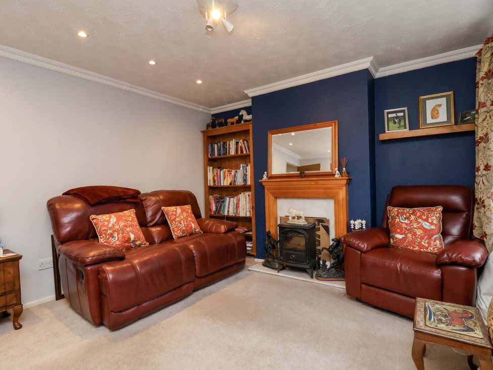 A living room with a sofa and armchair at 7 Crestbrooke Northallerton