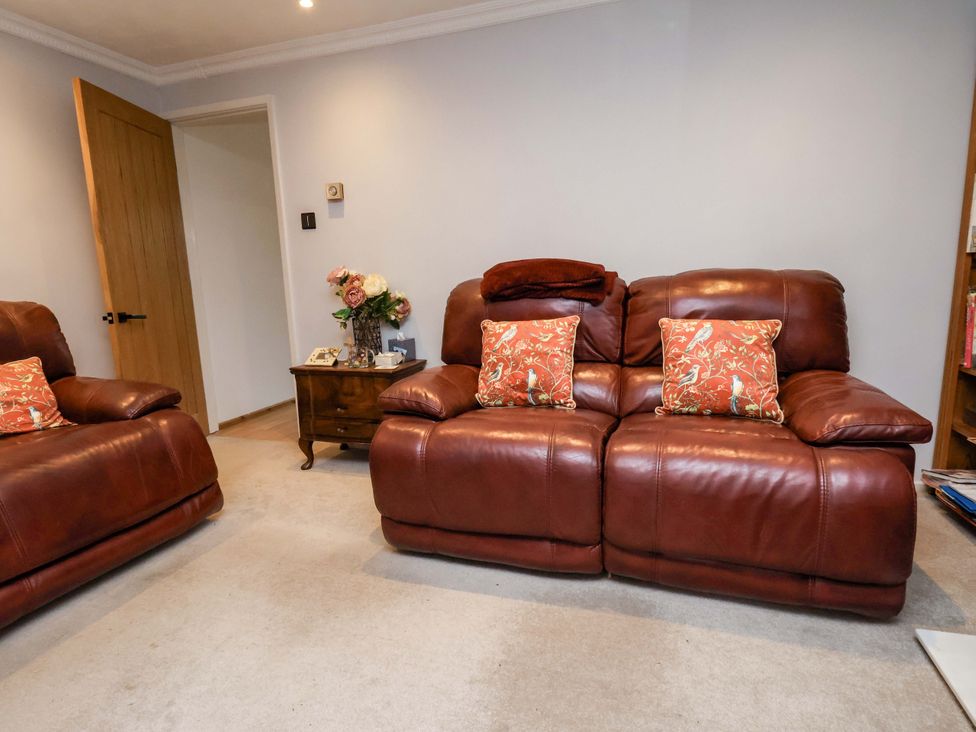 A living room with a sofa and coffee table at 7 Crestbrooke in Northallerton
