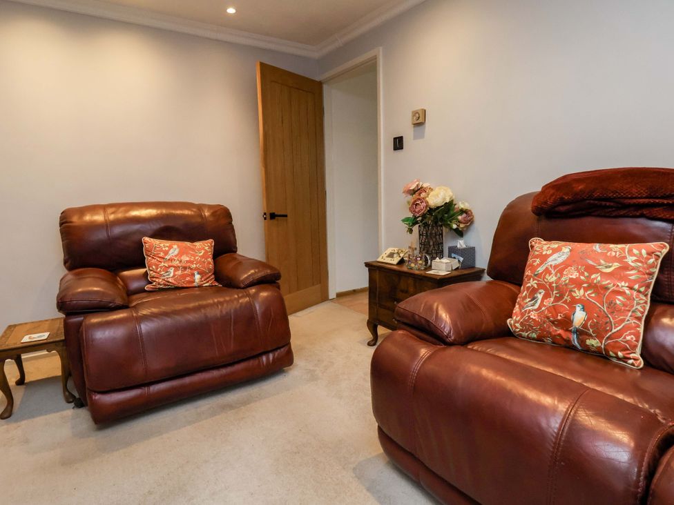 A living room with recliners and a coffee table at 7 Crestbrooke in Northallerton