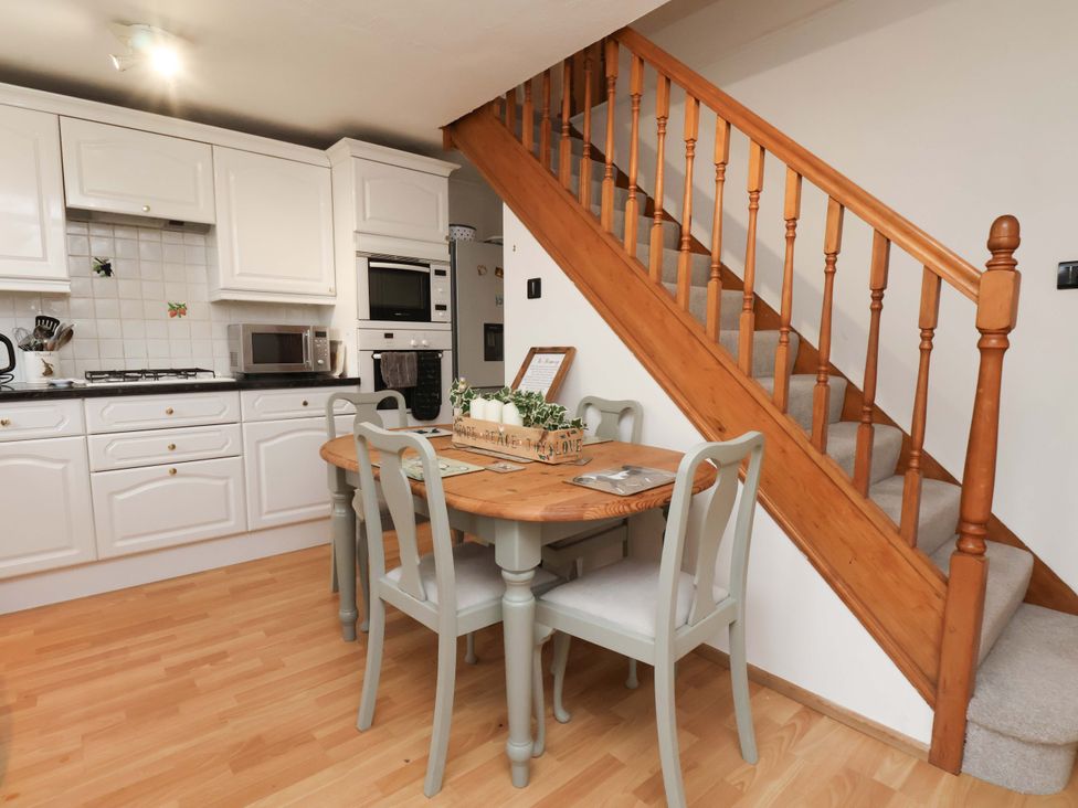 A kitchen with a table and chairs at 7 Crestbrooke in Northallerton
