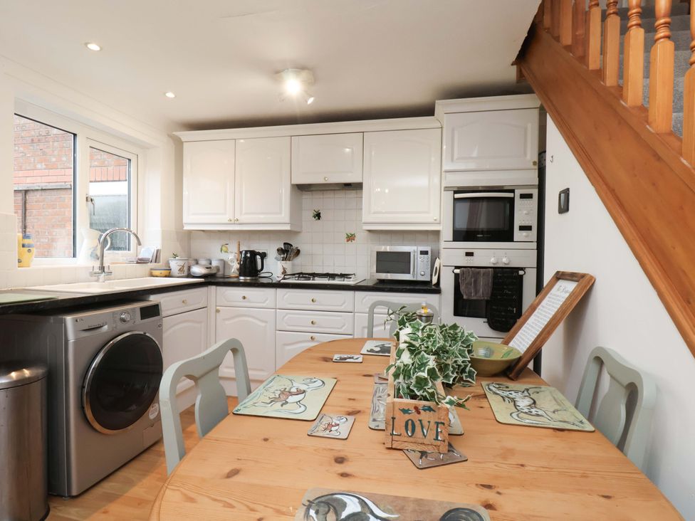 A kitchen with appliances and dining table at 7 Crestbrooke Northallerton