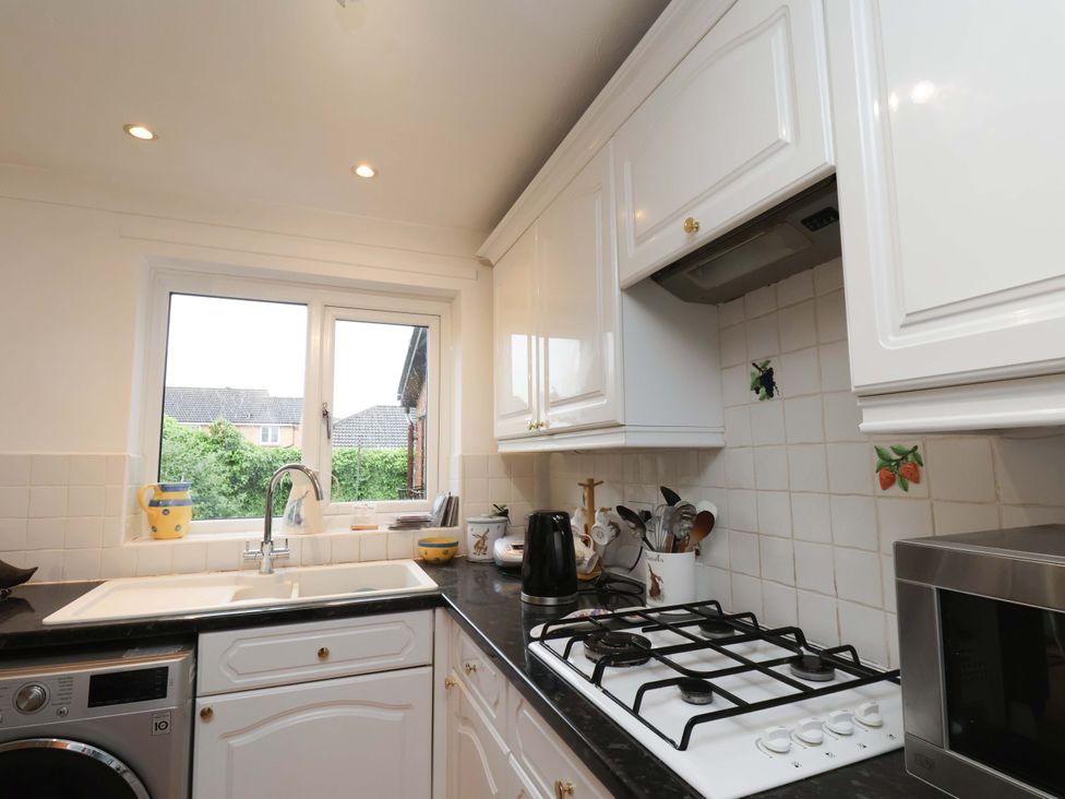 A kitchen with a sink and stove at 7 Crestbrooke Northallerton