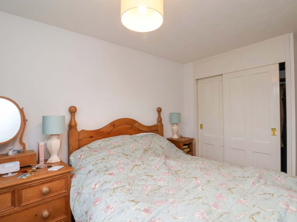A bedroom with a bed and dresser at 7 Crestbrooke in Northallerton