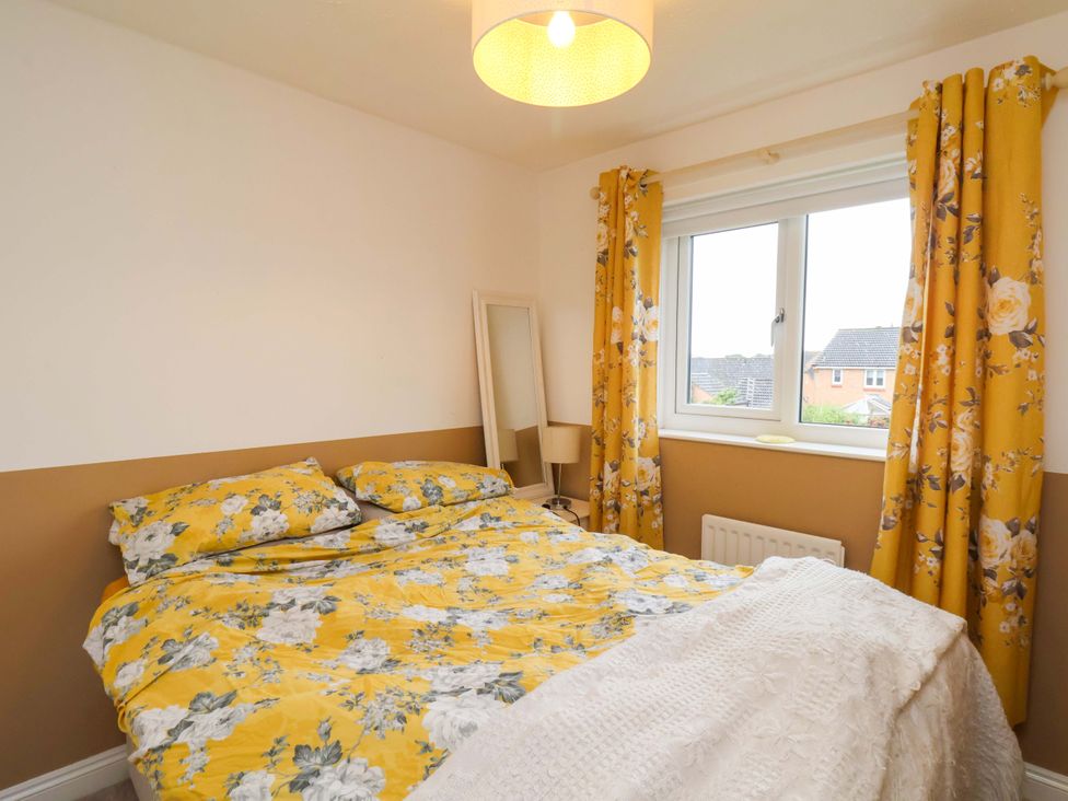 A bedroom with a bed and a window at 7 Crestbrooke in Northallerton