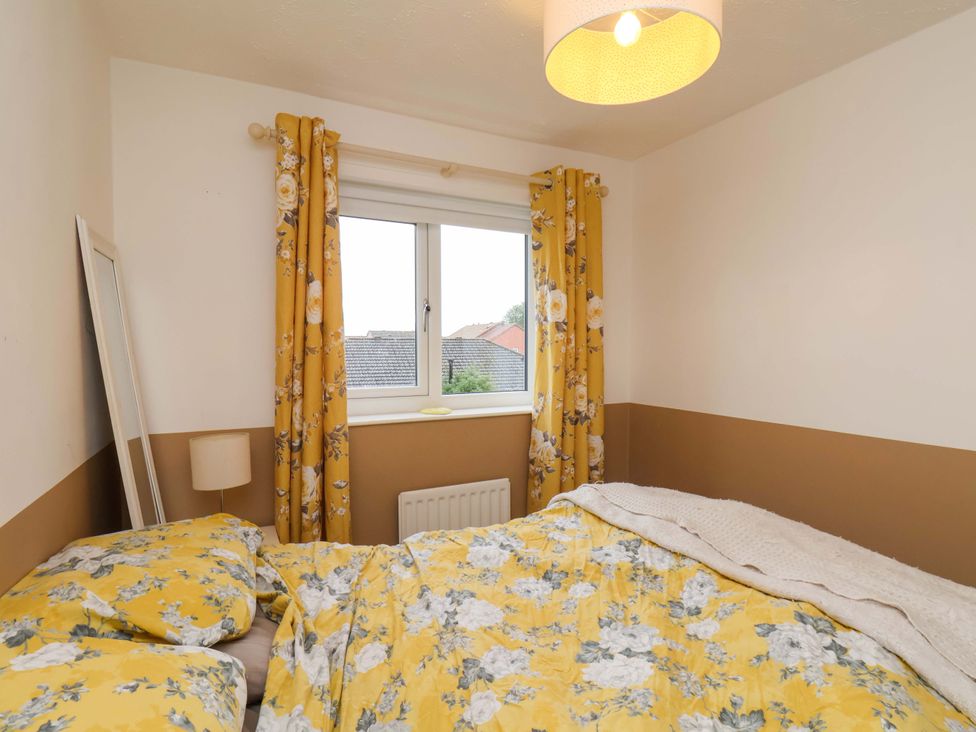 A bedroom with a bed and curtains at 7 Crestbrooke in Northallerton