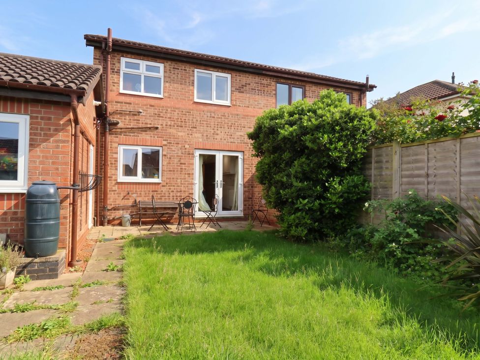 A garden with grass and seating area at 7 Crestbrooke Northallerton
