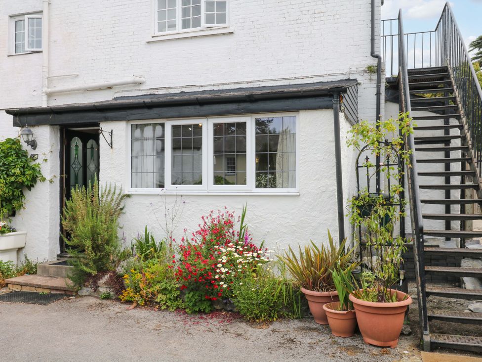 A house exterior with a flower bed and stairs at The Headmasters Quarters in Chudleigh