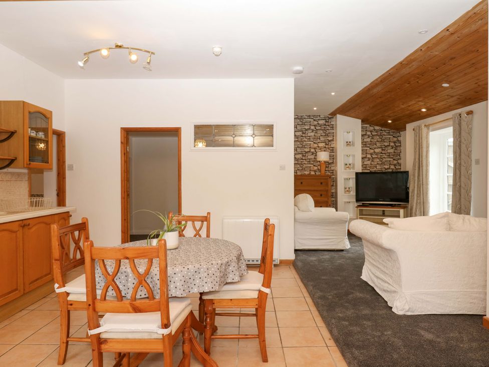 A living room with dining area and sofa at The Headmasters Quarters in Chudleigh