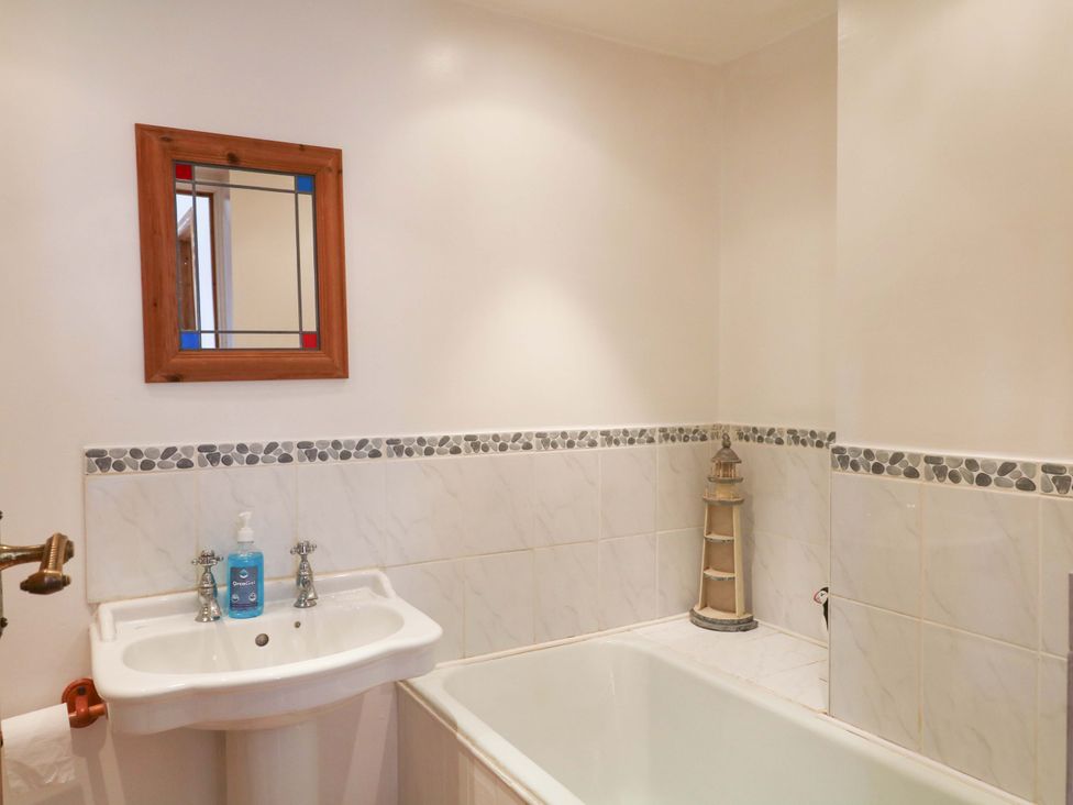 A bathroom with a sink and bath tub at The Headmasters Quarters Chudleigh