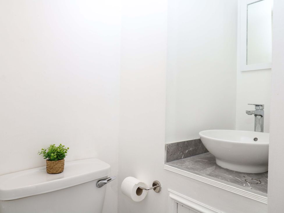 A bathroom with a toilet and sink at The Headmasters Quarters in Chudleigh