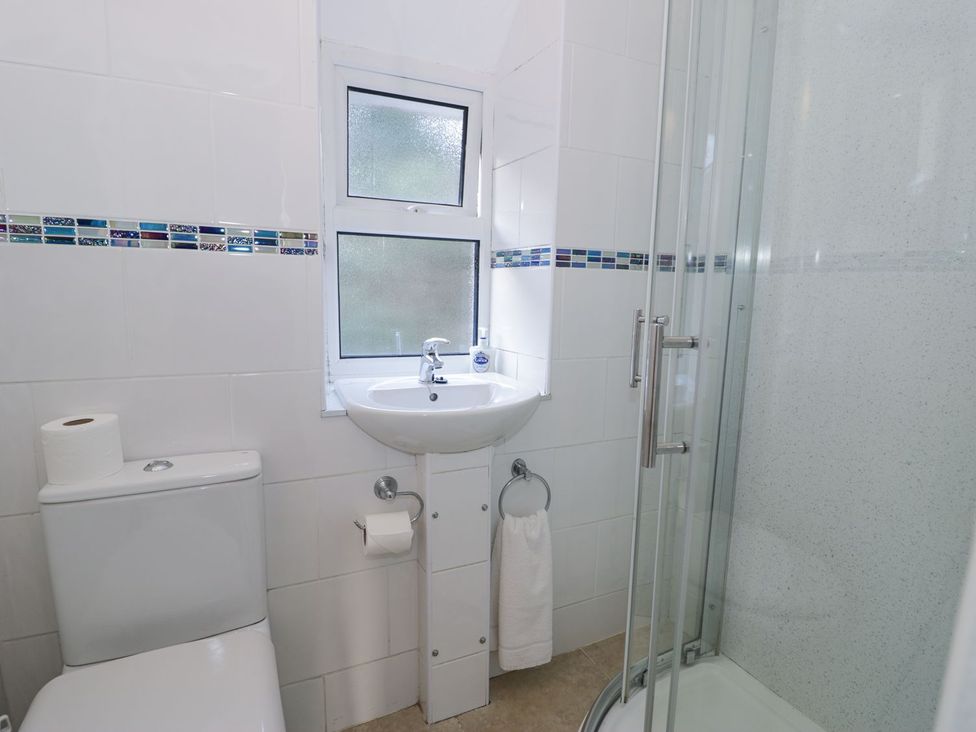 A bathroom with a sink and shower at Ty Gwyn in Aberdovey