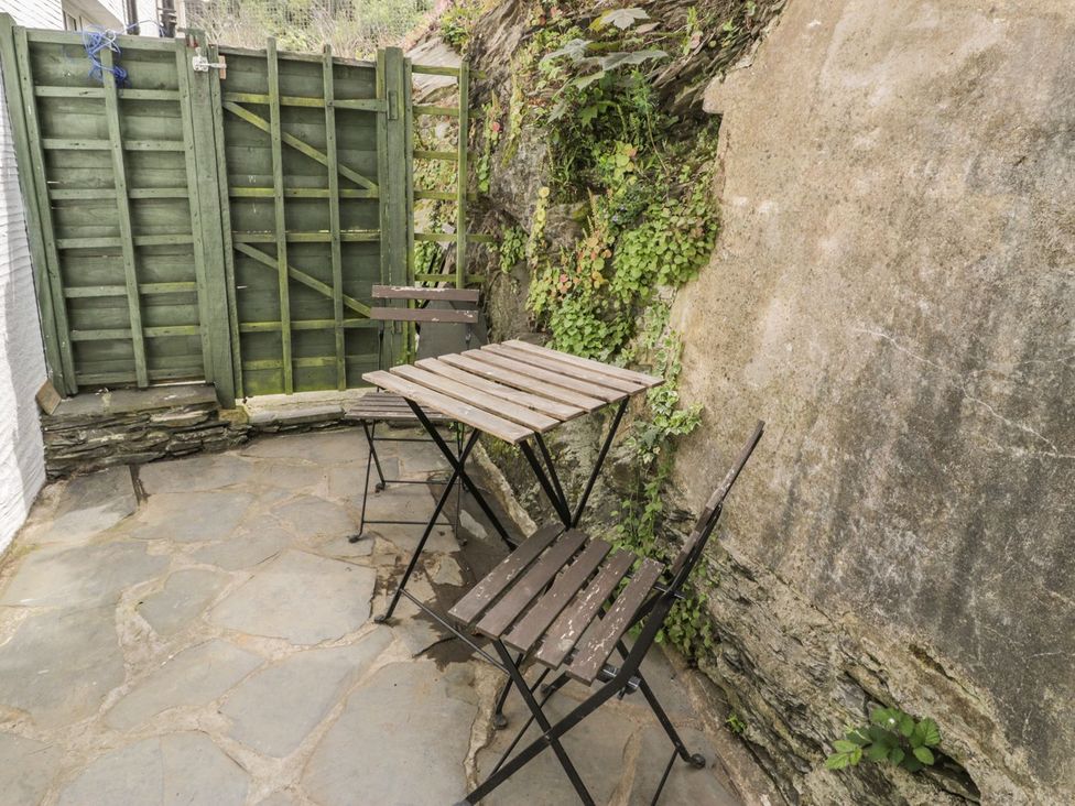 An outdoor patio with a table and chairs at Ty Gwyn in Aberdovey
