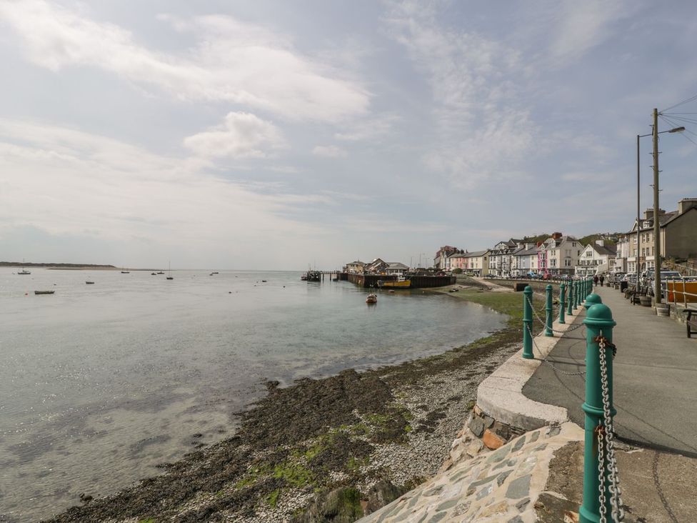 A coastal view with boats and a pier in Aberdovey