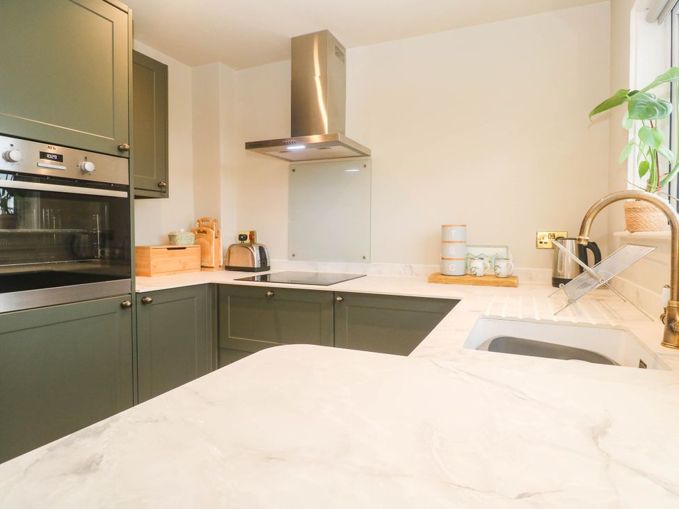 A kitchen with appliances and cabinets at 8 Yellow Sands in Padstow