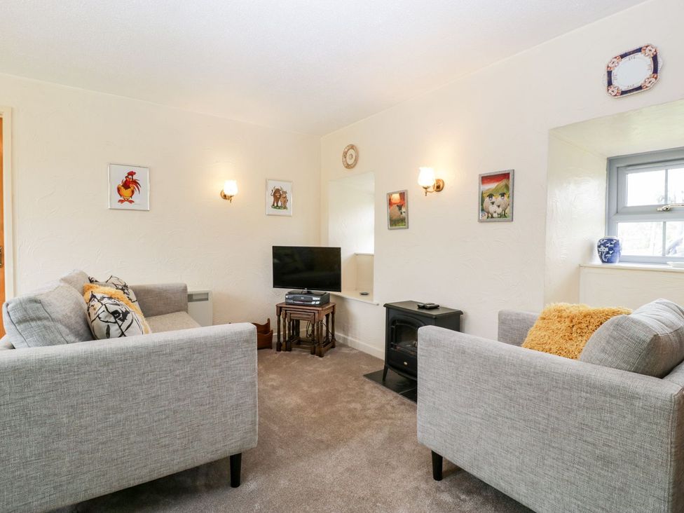 A living room with a sofa and television at Oak Tree in Weston-super-Mare