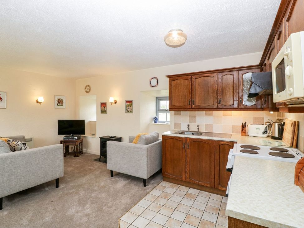 A kitchen with seating area and kitchen appliances at Oak Tree in Weston-super-Mare
