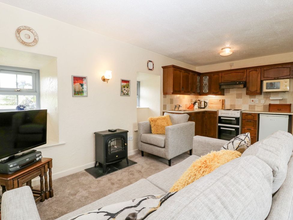 A living room with furniture and kitchen area at Oak Tree in Weston-super-Mare