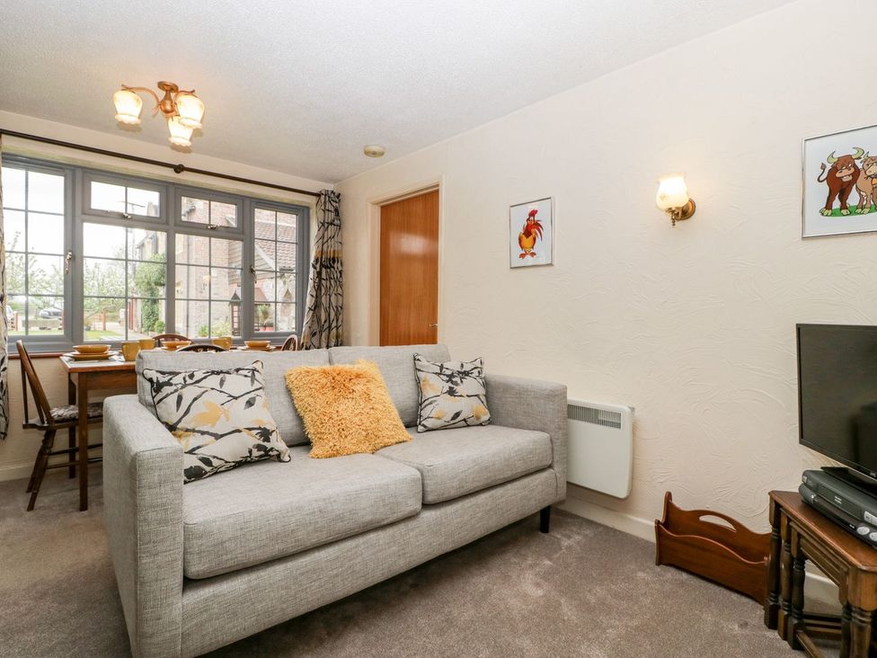 A living room with a sofa and television at Oak Tree in Weston-super-Mare
