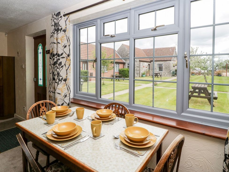 A dining room with a table set for a meal at Oak Tree in Weston-super-Mare