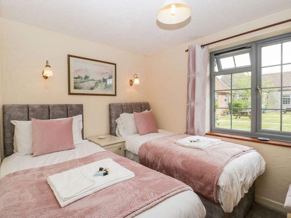 A bedroom with two beds and a window at Oak Tree in Weston-super-Mare