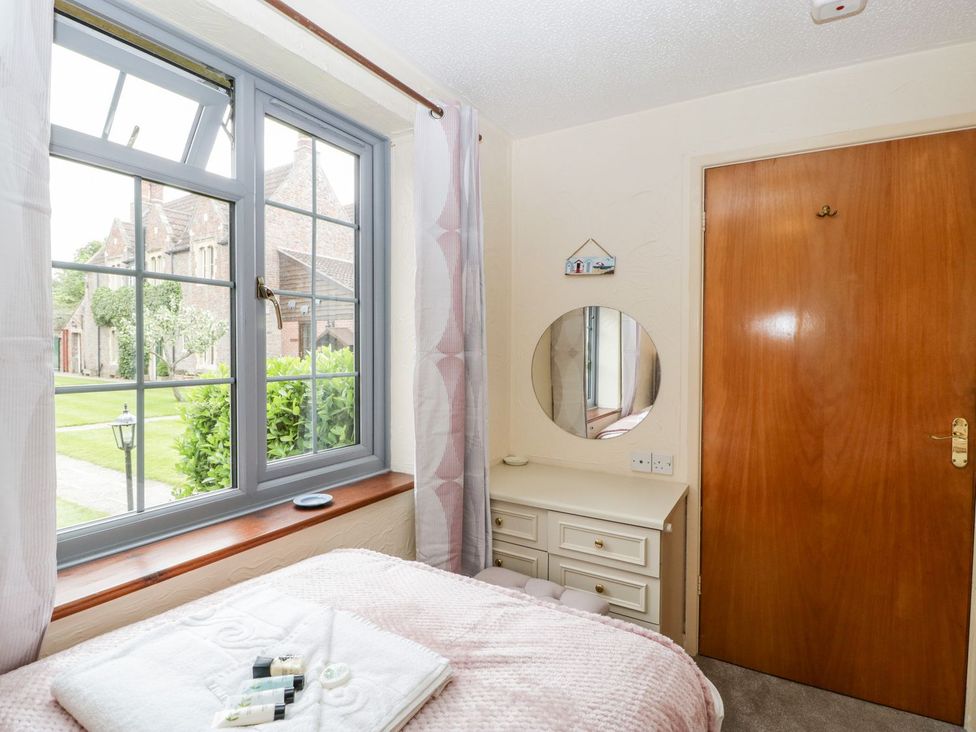 A bedroom with a bed and window at Oak Tree in Weston-super-Mare