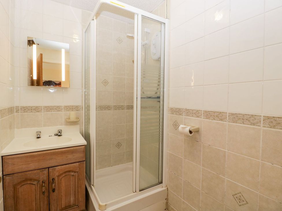 A bathroom with a shower and sink at Oak Tree in Weston-super-Mare