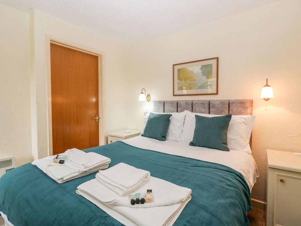 A bedroom with a bed and towels at Oak Tree in Weston-super-Mare