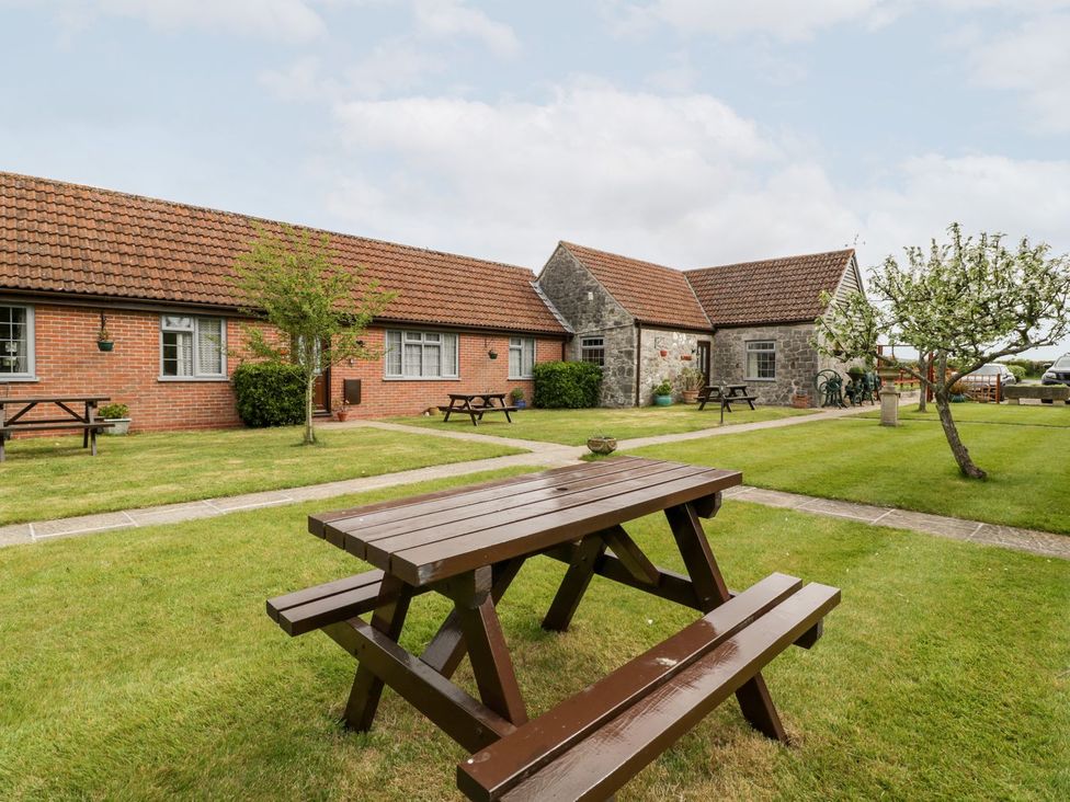 An outdoor area with a table and benches at Oak Tree in Weston-super-Mare
