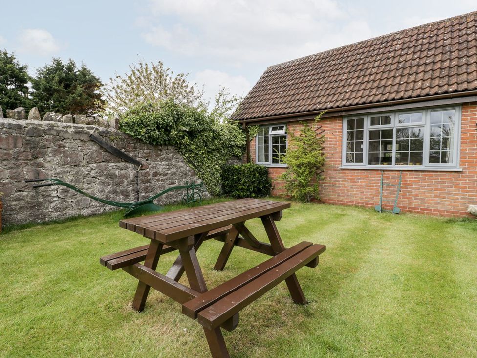 A garden with a picnic table and brick wall at Oak Tree Weston-super-Mare
