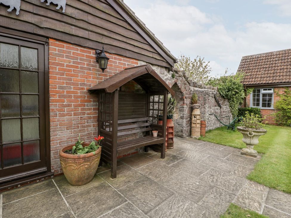 A garden area with stone pathway and wooden bench at Oak Tree Weston-super-Mare