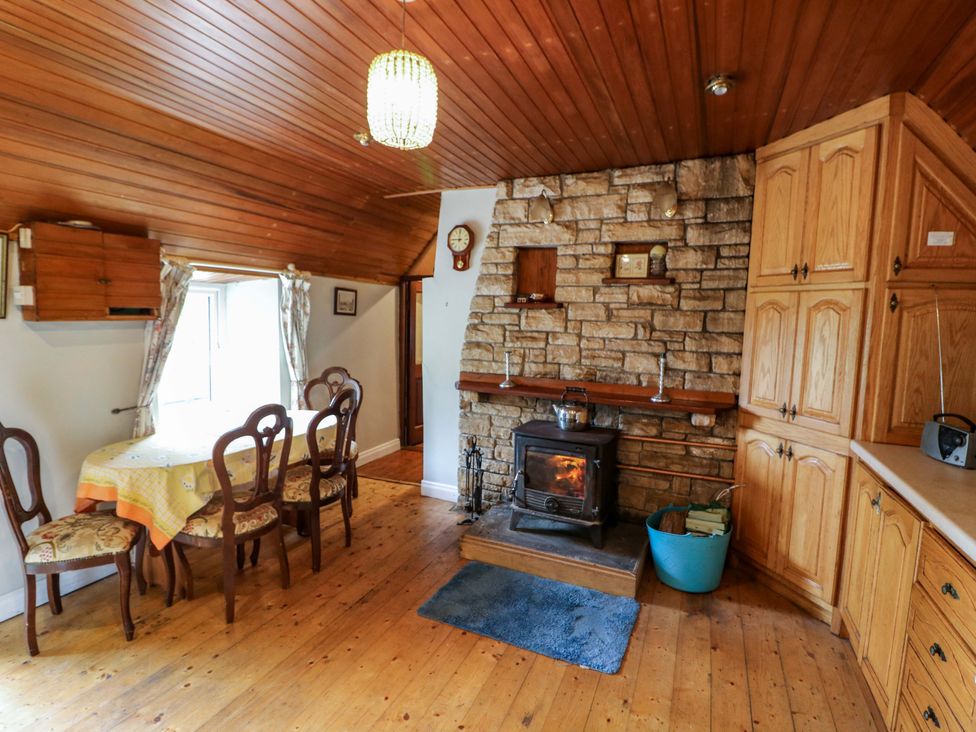 A dining room with a wooden table and chairs at Gullane East, Rathmore, County Kerry