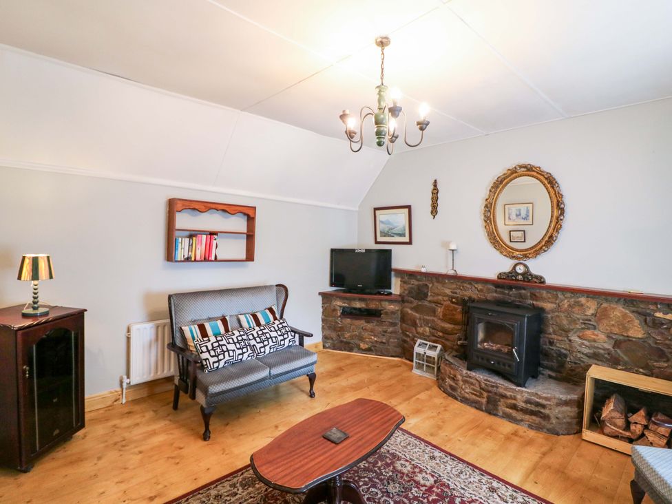 A living room with a sofa and a television at Gullane East in Rathmore, County Kerry