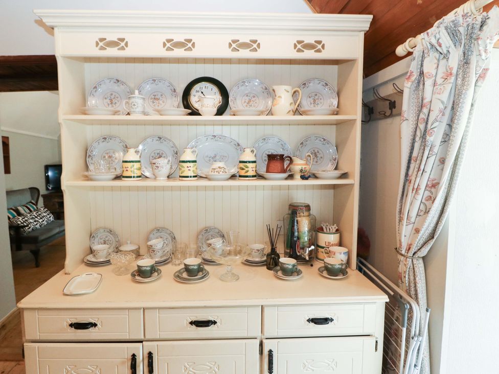 A kitchen with plates and cups displayed on a shelf at Gullane East in Rathmore, County Kerry