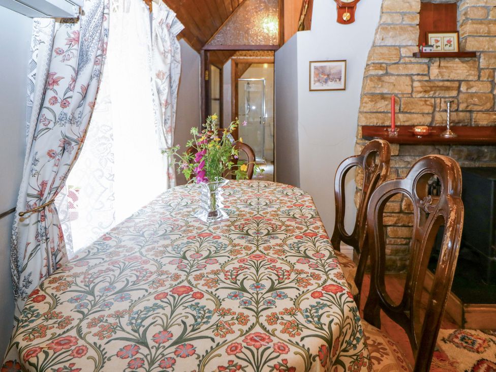 A dining room with a table and chairs at Gullane East in Rathmore, County Kerry