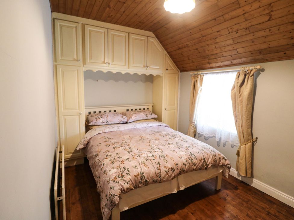 A bedroom with a bed and wardrobe at Gullane East, Rathmore, County Kerry