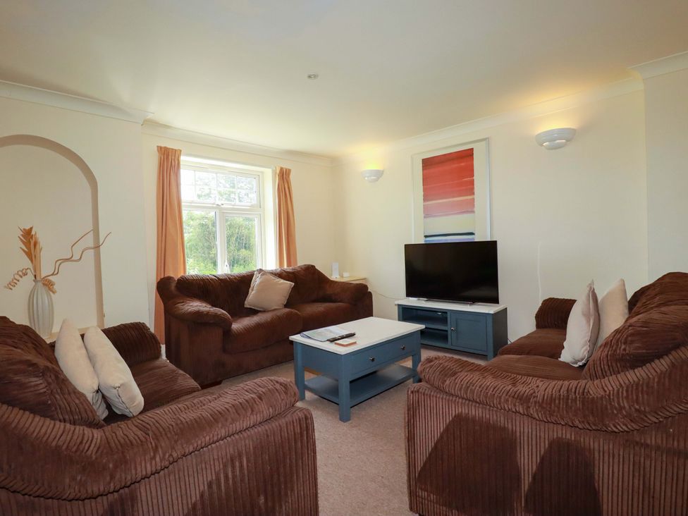 A living room with sofas and a television at 4 bed number 2 Atlantic Reach near St Columb Road