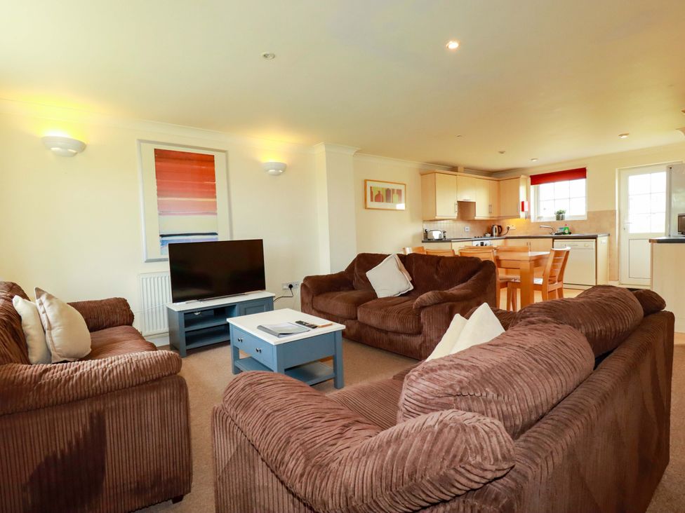 A living room with a sofa and television at 4 bed number 2 Atlantic Reach near St Columb Road