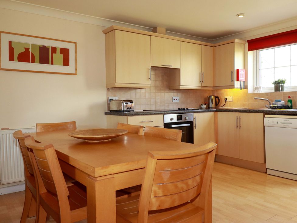 A kitchen with a table and chairs at 4 bed number 2 in Atlantic Reach near St Columb Road