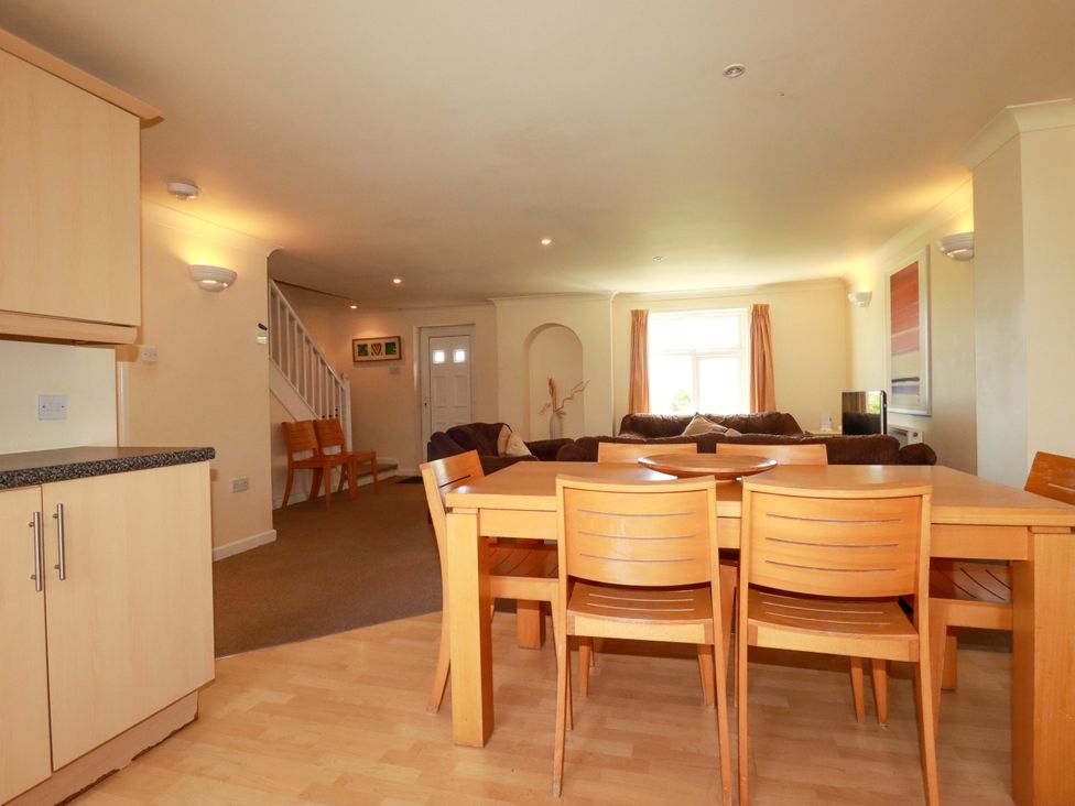 A dining area with a table and chairs at 4 bed number 2 Atlantic Reach near St Columb Road