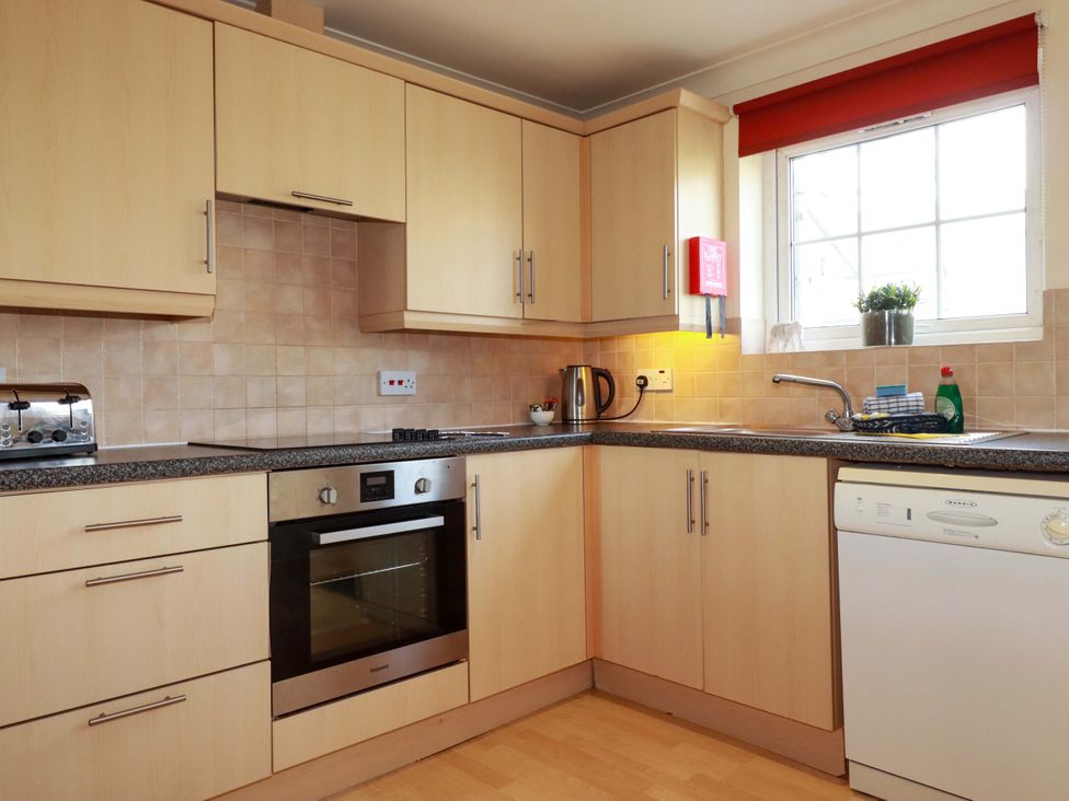A kitchen with cabinets, oven, and sink at 4 bed number 2 Atlantic Reach near St Columb Road