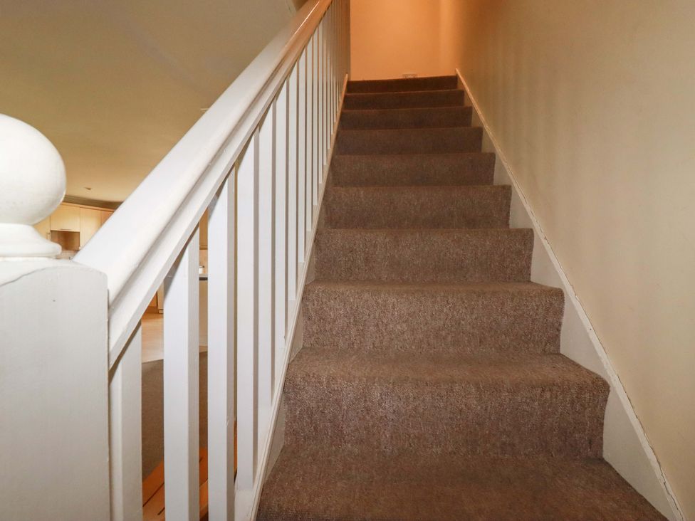 A staircase with carpet and a handrail at 4 bed number 2 Atlantic Reach near St Columb Road