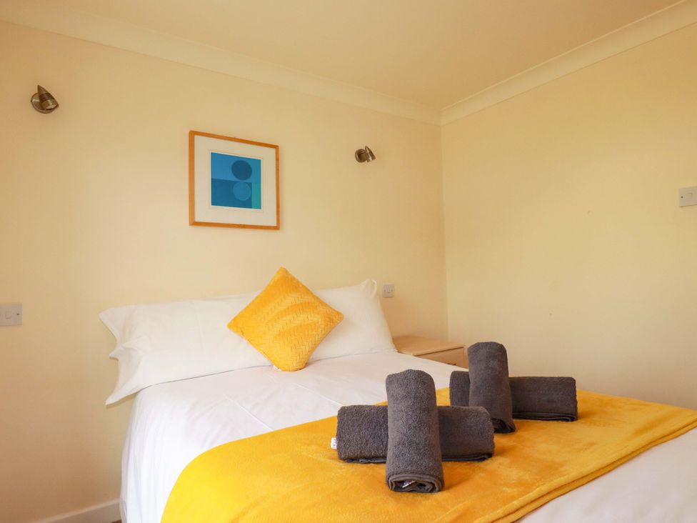 A bedroom with a bed and towels on a blanket at 4 bed number 2 Atlantic Reach near St Columb Road