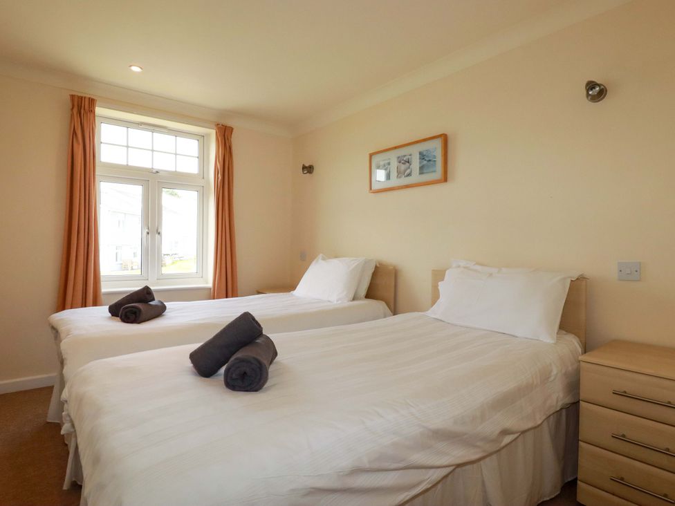 A bedroom with two beds and a window at 4 bed number 2 Atlantic Reach near St Columb Road