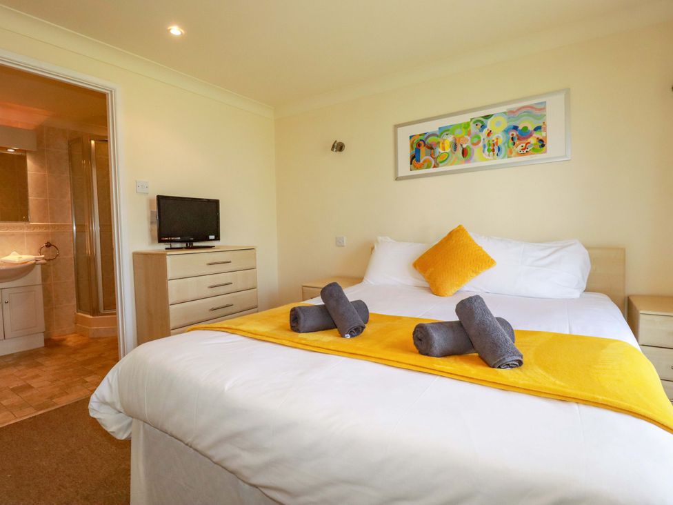 A bedroom with a bed and television at 4 bed number 2 Atlantic Reach near St Columb Road