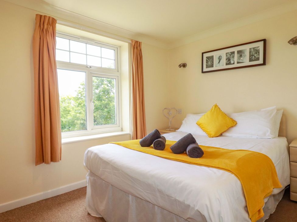 A bedroom with a bed and window at 4 bed number 2 Atlantic Reach near St Columb Road
