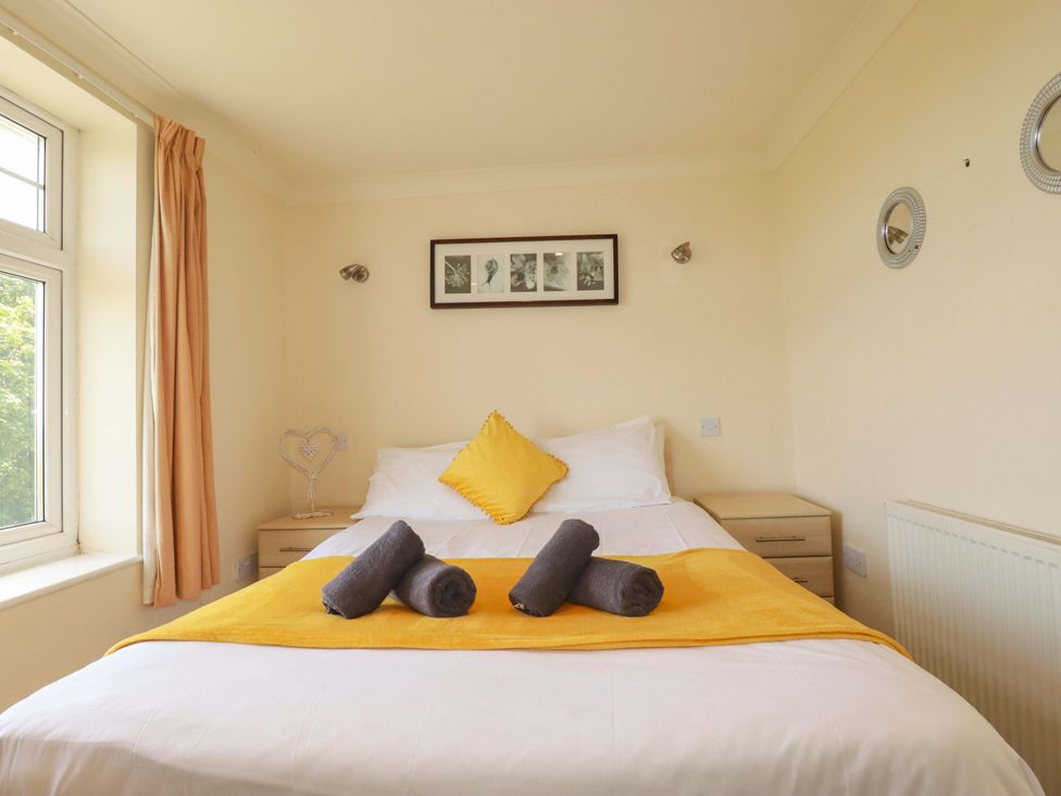 A bedroom with a bed and decorative pillows at 4 bed number 2 Atlantic Reach near St Columb Road