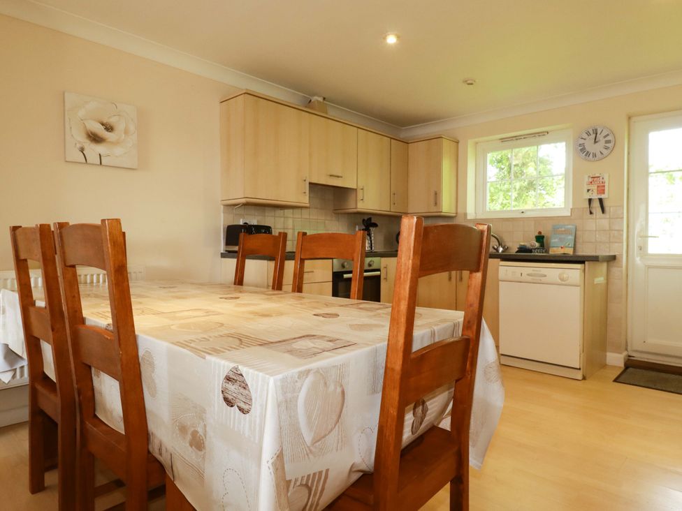 A kitchen with a dining table and chairs at 4 bed number 20 Newquay