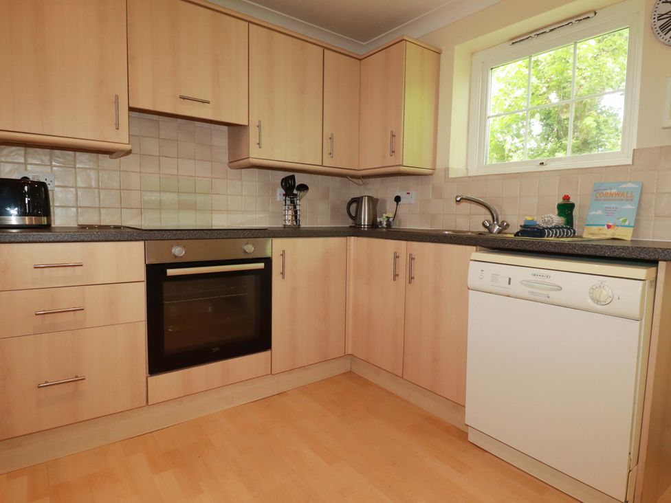 A kitchen with cabinets and appliances at 4 bed number 20 Newquay