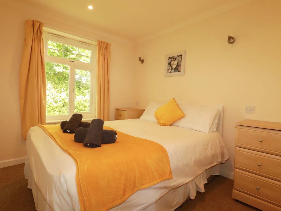 A bedroom with a bed and window at 4 bed number 20 Newquay