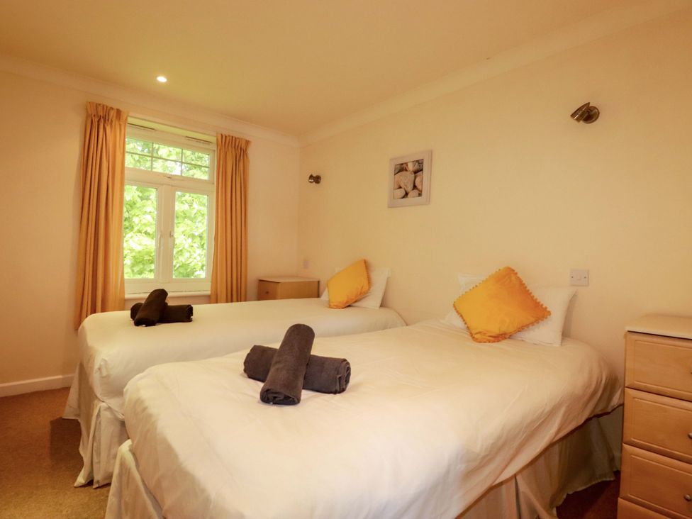 A bedroom with two beds and a window at 4 bed number 20 Newquay